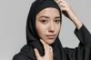 Studio portrait of a woman wearing a hijab with her hands gracefully posed. Captures beauty and confidence.